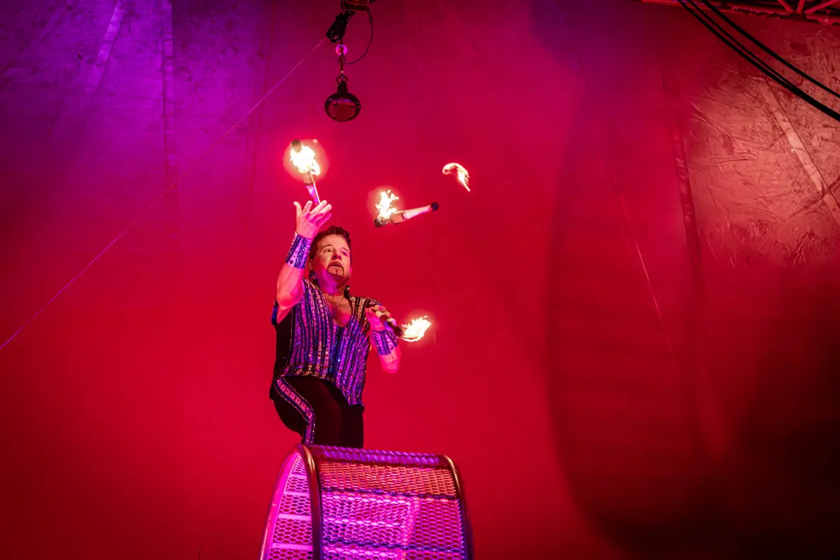 Circus Performer Juggling Fire On Wheel - Royal Canadian Circus